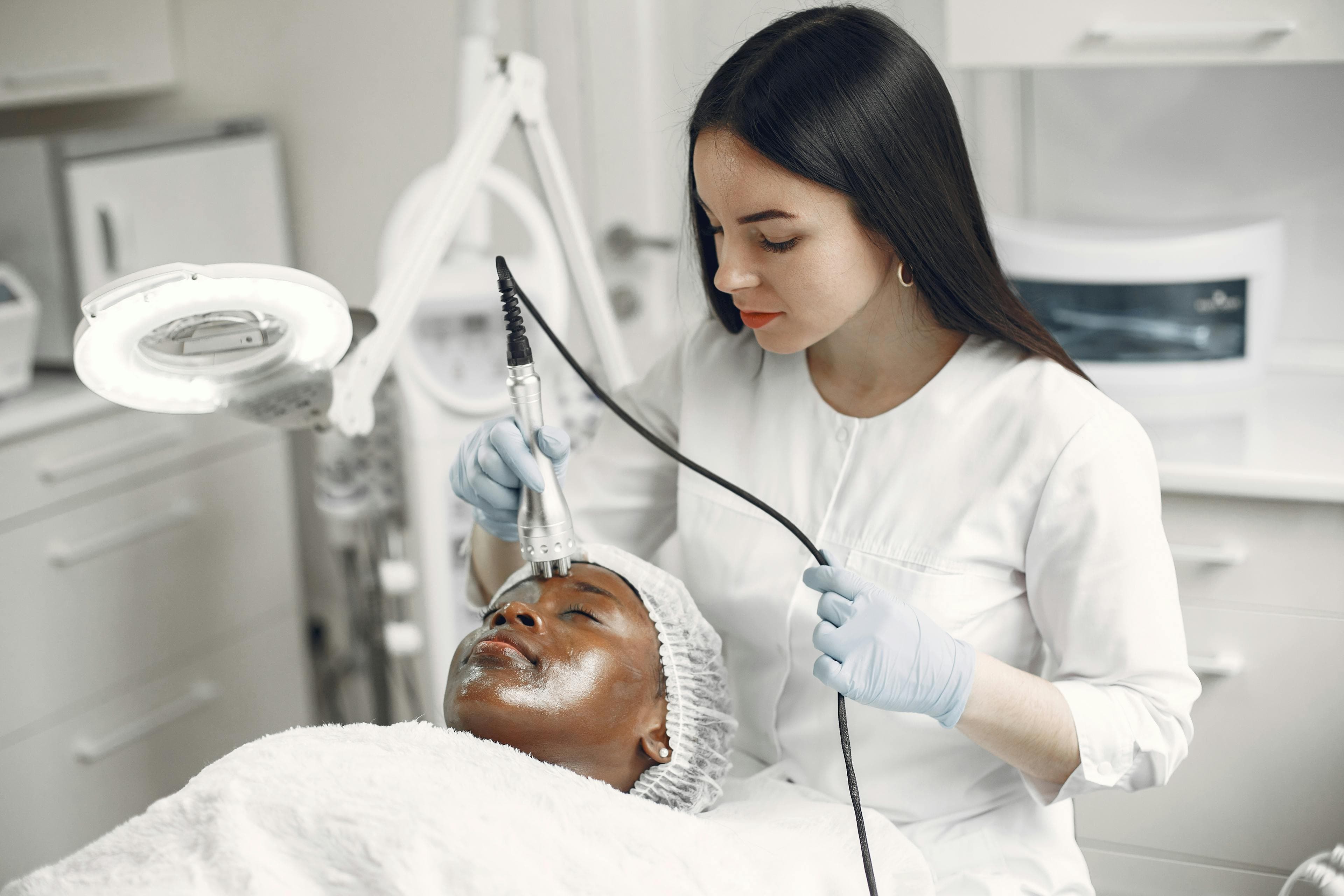 A radiofrequency skin-tightening handpiece being worked across the face